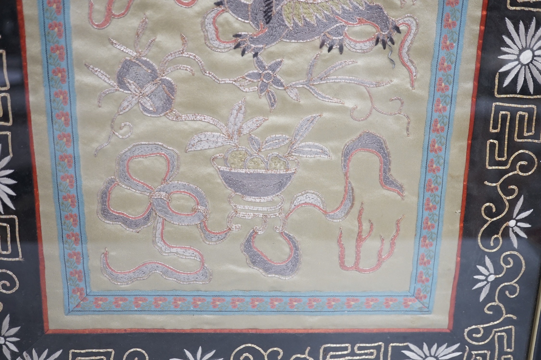A framed Chinese dragon silk panel. 64 x 34cm
